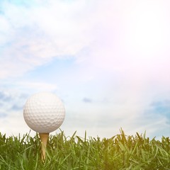 golf ball with a golf tee on a grass