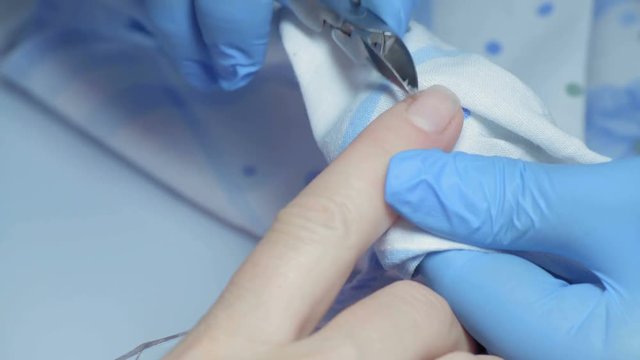 Close-up, Master Manicure Cuts off Katikuly on Girl's Finger