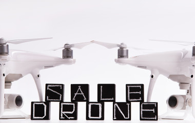 Flying drones lie on a white background. Theme selling and buying drone.