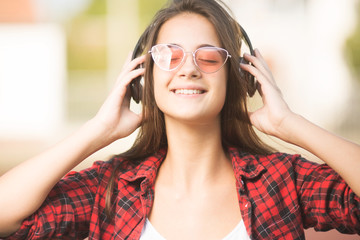 Beautiful young woman listening to music and smiling