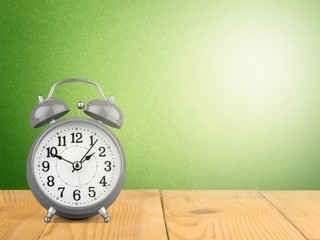 Blue Retro alarm clock on wooden table on wall background