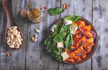 roasted pumpkin slices, spinach leaves, Camembert brie cheese, cashews, sauce. vegetarian salad ,dish