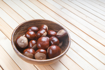 Roasted Chestnuts in the plate for Christmas on wooden background