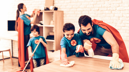 Fototapeta premium Happy Cute Super Heroes Family Cleaning Room