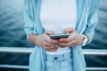 Close-up young woman using smart phone