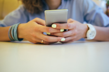 Fototapeta premium Woman using smart phone in cafe