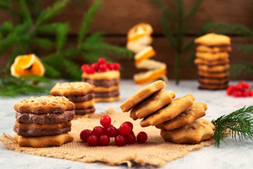 Cookies with a chocolate layer-dessert for the holiday, Christmas decorations, red viburnum, falling stack of cookies.