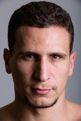 Obraz premium Face of young muscular Persian man against gray background