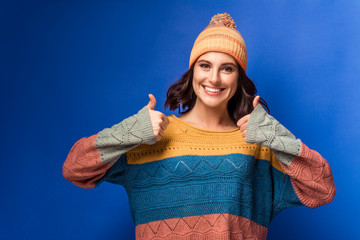 smiling girl in knitted sweater and yellow hat 