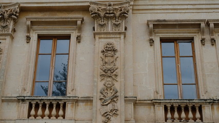 City of Noto. Province of Syracuse, Sicily. Ppart of the ornamented facade of Teatro Comunale "Vittorio Emanuele". Details included a lion head, a  human head, partitures and variuos instruments.