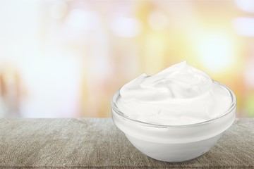 close up of a white beauty cream or yogurt on white background