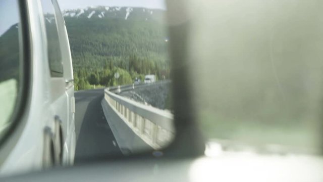 Close up, Norway landscape in side view mirror of car