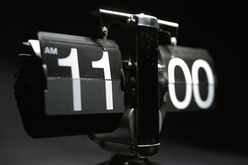 Classic flip clock watch face showing hour and minutes set to 11:00 AM	