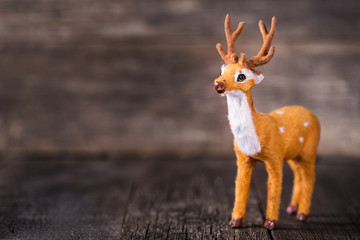 Toy of deer on wooden background