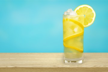 Lemonade with fresh lemon on  background
