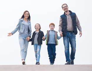 Happy family holding hands and walking