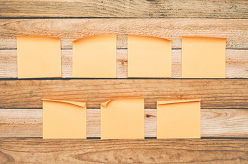 Empty paper stickers on wooden background