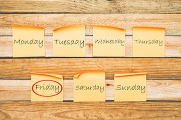 Friday. Days of the week. Paper stickers with inscriptions on wooden boards
