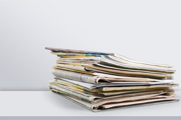 Pile of newspapers on white background