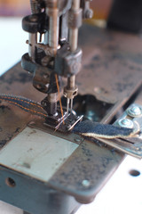 Closeup part of an old sewing machine and detail on needle & thread,presser foot