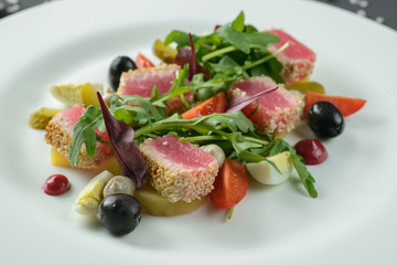 Salad with ham on white plate