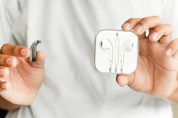 Hearing aid and earphone. The concept of hearing care.