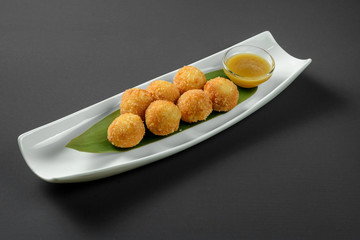 Cheese balls on narrow plate