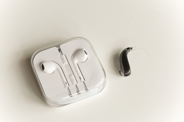 Hearing aid and earphone. The concept of hearing care.