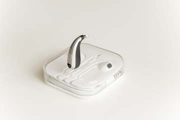Hearing aid and earphone. The concept of hearing care.