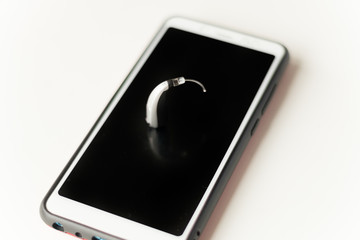 Hearing aid and earphone. The concept of hearing care.