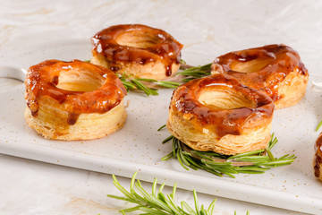 Typical Portuguese pastry Glorias, tender puff pastry topped with handmade caramel candy and special sugar syrup.