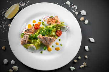 Fried salmon on white plate