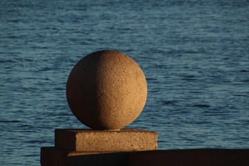 granite ball near the water on the city embankment