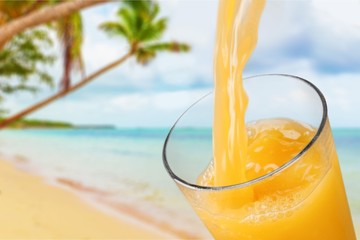 Orange juice glass on background