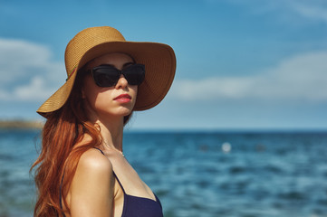 Young woman in swimsuit at the seaside resort