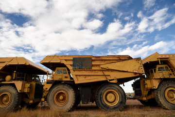Giant industrial coal mining trucks, open pit mining, in the Powder River Basin.