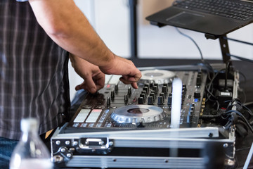 Deejay uses controls at event to entertain and amuse