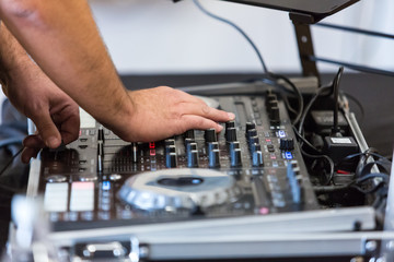 Deejay uses controls at event to entertain and amuse