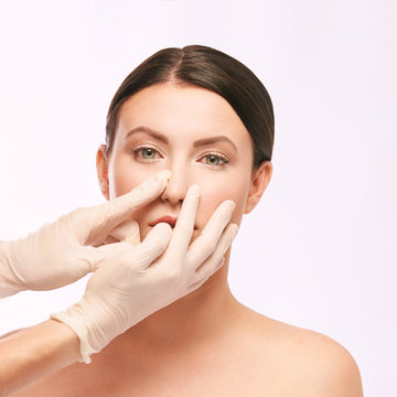 Plastic medical consultation. Doctor hands. Woman face
