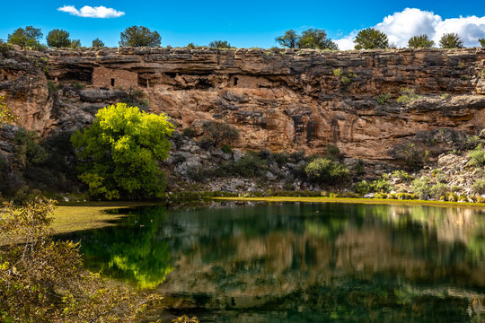 Ancient ruins and surroundings reflect on the quiet water of Montezuma Well. Part of Montezuma Castle National Monument.