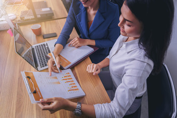 Businesswomen analyzing data together in teamwork for planning and startup new project.