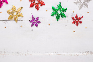 Top view of snowflakes on wooden white background and copy space. Christmas concept.