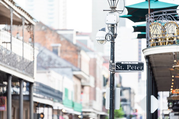 Old town St Peter Chartres street intersection sign in New Orleans, Louisiana town, city, restaurants, bars during evening sunset, architecture, nightlife