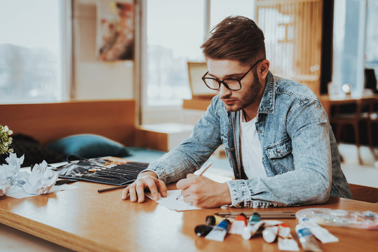 Handsome Freelance Male Artist Painting On Pape