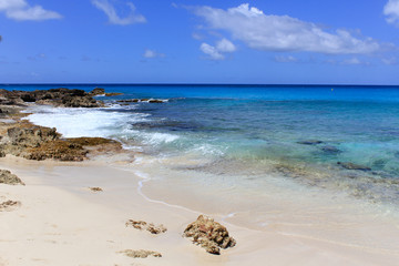 Fototapeta na wymiar Ocean coast with white sandy coast and turquoise colorful waters