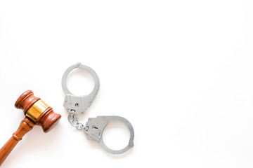 Arrest concept. Metal handcuffs near judge gavel on white background top view space for text