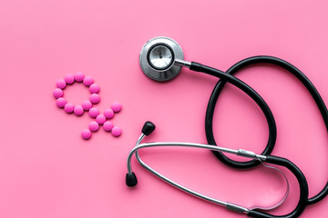 Female diseases concept. Stethoscope near female sign on pink background top view