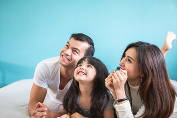 Portrait happy Asian family over blue background