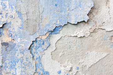 Old weathered blue plaster wall texture. Grunge background.