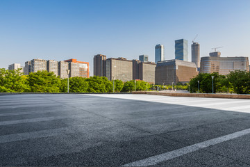 Fototapeta na wymiar Panoramic skyline and modern business office buildings with empty road,empty concrete square floor